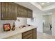 Kitchen countertop with vintage cabinets, setting for two, view of dining room and oven at 11113 W Cameo Dr, Sun City, AZ 85351