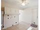 Laundry room with tile flooring and hookups, adjacent to an exterior door at 11113 W Cameo Dr, Sun City, AZ 85351