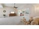 Bright living room with ceiling fan, television, and striped sofa at 11113 W Cameo Dr, Sun City, AZ 85351