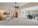 Open-concept living room with neutral colors, ceiling fan, and views to the dining area at 11113 W Cameo Dr, Sun City, AZ 85351