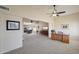 Open living room with ceiling fan, adjacent to dining room and office space at 11113 W Cameo Dr, Sun City, AZ 85351