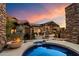 Inviting backyard with a fire pit, spa, and outdoor seating area under a covered patio at 11240 E Apache Vistas Dr, Scottsdale, AZ 85262