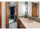 Modern bathroom with stone countertops, tiled shower and stone floors at 11240 E Apache Vistas Dr, Scottsdale, AZ 85262