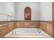 Bathtub with tile surround, a window with shutters, and tile accents at 11240 E Apache Vistas Dr, Scottsdale, AZ 85262