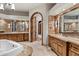 Bathroom featuring double sinks, decorative mirrors, and marble countertops at 11240 E Apache Vistas Dr, Scottsdale, AZ 85262