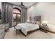 Bedroom featuring a gray headboard, sunset view, and decorative window at 11240 E Apache Vistas Dr, Scottsdale, AZ 85262