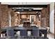 Open-concept dining area featuring stone accents, modern lighting, and seamless flow into the kitchen at 11240 E Apache Vistas Dr, Scottsdale, AZ 85262