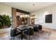 Elegant dining room with stylish lighting, dark wood table, seating for eight, and stone archway at 11240 E Apache Vistas Dr, Scottsdale, AZ 85262