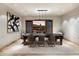 Contemporary dining room with a large table, statement artwork, and sliding glass doors offering scenic outdoor views at 11240 E Apache Vistas Dr, Scottsdale, AZ 85262