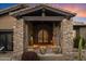 Charming front entrance with stone columns, dark wood accents and desert landscaping at 11240 E Apache Vistas Dr, Scottsdale, AZ 85262