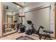 Brightly lit exercise room featuring floor to ceiling mirror, mounted TV and workout equipment at 11240 E Apache Vistas Dr, Scottsdale, AZ 85262