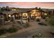 Lush backyard featuring a covered patio, desert landscaping, and outdoor seating areas at 11240 E Apache Vistas Dr, Scottsdale, AZ 85262
