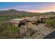 Beautiful home with a tile roof, desert landscaping, mountain views and outdoor living space at 11240 E Apache Vistas Dr, Scottsdale, AZ 85262