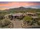 Home exterior showing the desert landscaping, architectural details, and overall curb appeal at 11240 E Apache Vistas Dr, Scottsdale, AZ 85262
