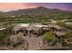 Expansive estate with lush landscaping, desert vegetation, mountain views, and a circular driveway at 11240 E Apache Vistas Dr, Scottsdale, AZ 85262