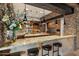 Kitchen with stone accents, wood cabinets, granite countertops, and a large island at 11240 E Apache Vistas Dr, Scottsdale, AZ 85262