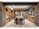 Spacious kitchen featuring wood cabinets, stone accents, central island with seating, and modern stainless steel appliances at 11240 E Apache Vistas Dr, Scottsdale, AZ 85262