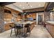 Kitchen with stone accents, wood cabinets, granite countertops, and center island with seating at 11240 E Apache Vistas Dr, Scottsdale, AZ 85262