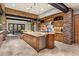 Expansive kitchen boasting a large island, stone accents, stainless steel appliances, and a seamless connection to the dining area at 11240 E Apache Vistas Dr, Scottsdale, AZ 85262