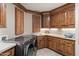 Well-organized laundry room with wood cabinets, stainless steel washer and dryer at 11240 E Apache Vistas Dr, Scottsdale, AZ 85262