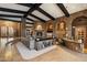 Spacious living room featuring stone accents, wood beam ceilings, and a cozy fireplace at 11240 E Apache Vistas Dr, Scottsdale, AZ 85262