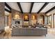 Comfortable living room with stone details, dark wood beams, fireplace, and sectional sofa at 11240 E Apache Vistas Dr, Scottsdale, AZ 85262
