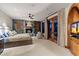Spacious main bedroom with stone fireplace, lounge area, and scenic outdoor views at 11240 E Apache Vistas Dr, Scottsdale, AZ 85262