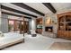 Bedroom featuring a fireplace, wooden beam ceiling and large windows at 11240 E Apache Vistas Dr, Scottsdale, AZ 85262