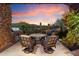 Inviting outdoor patio with a dining area, grill, and views of the golf course and sunset sky at 11240 E Apache Vistas Dr, Scottsdale, AZ 85262