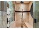 Walk-in shower featuring a glass enclosure, stone surround, and dual shower heads at 11240 E Apache Vistas Dr, Scottsdale, AZ 85262