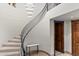 Elegant curved staircase with wrought iron railing and stylish lighting at 11240 E Apache Vistas Dr, Scottsdale, AZ 85262