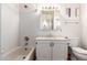 Well-maintained bathroom features white tile, a tub and shower, and modern vanity at 11243 E Jenan Dr, Scottsdale, AZ 85259
