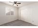 Bedroom featuring shuttered windows and a closet with mirrored doors at 11243 E Jenan Dr, Scottsdale, AZ 85259
