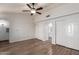 Spacious primary bedroom with hardwood floors, ceiling fan, and closet at 11243 E Jenan Dr, Scottsdale, AZ 85259