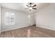 Bedroom featuring wood floors, a ceiling fan, and a side door at 11243 E Jenan Dr, Scottsdale, AZ 85259