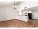 Dining room features hardwood floors, a chandelier, and opens to the kitchen area at 11243 E Jenan Dr, Scottsdale, AZ 85259