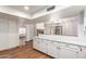Open kitchen with white cabinets and long countertop to dining space at 11243 E Jenan Dr, Scottsdale, AZ 85259