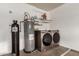 This laundry area features a water heater and a modern washer and dryer set at 11243 E Jenan Dr, Scottsdale, AZ 85259