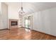 Bright living room with brick fireplace, backyard access, and built-in shelving at 11243 E Jenan Dr, Scottsdale, AZ 85259