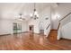 Open floorplan features wood floors, stairs, fireplace, ceiling fan, and sliding doors to the backyard at 11243 E Jenan Dr, Scottsdale, AZ 85259