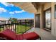 Relaxing balcony with outdoor seating and a view of the well-manicured community grounds at 11640 N Tatum Blvd # 3091, Phoenix, AZ 85028