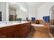 Spacious bathroom with double sinks, a soaking tub, walk-in shower, and warm wood cabinetry at 11640 N Tatum Blvd # 3091, Phoenix, AZ 85028