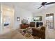 Cozy living room with a fireplace, comfortable seating, and a ceiling fan at 11640 N Tatum Blvd # 3091, Phoenix, AZ 85028