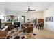 Inviting living room with a fireplace, comfortable seating, decorative rug, ceiling fan and natural light at 11640 N Tatum Blvd # 3091, Phoenix, AZ 85028
