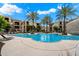 Resort-style pool area surrounded by palm trees and comfortable lounge chairs for relaxation and leisure at 11640 N Tatum Blvd # 3091, Phoenix, AZ 85028