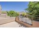 Balcony view with lovely desert scenery, blue sky, and lush, green trees at 11752 N 135Th Pl, Scottsdale, AZ 85259