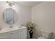 Half bathroom featuring white vanity with modern sink and fixtures, plus a toilet with a plant accent at 11752 N 135Th Pl, Scottsdale, AZ 85259