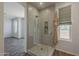 Modern bathroom with a glass-enclosed shower, stylish tile, and neutral color palette at 11752 N 135Th Pl, Scottsdale, AZ 85259