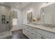 Bathroom featuring double sinks, granite counters, generous cabinet space, and walk-in shower at 11752 N 135Th Pl, Scottsdale, AZ 85259