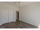 Bedroom with wood floors, closet and access to bathroom at 11752 N 135Th Pl, Scottsdale, AZ 85259